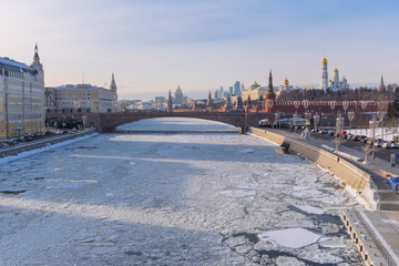 Winter city landscape in Moscow with a view of the Kremlin and the embankments of the Moscow River in ice