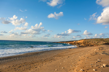 Fototapeta na wymiar Beautiful view of the seashore at sunset in soft golden light. Toxeftra Beach, Cyprus