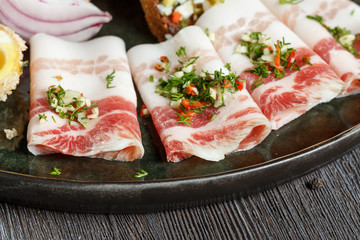 Lard plate with salt cucumbers and marinated garlic.