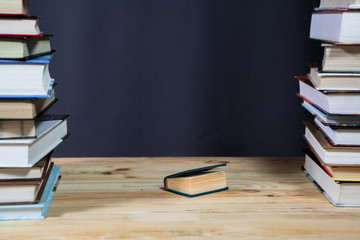 Pile of various books on wooden background