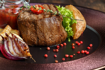 steak medallion. restaurant food. wood background