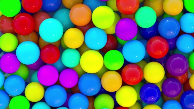 colorful bouncing balls outdoors against blue sunny sky