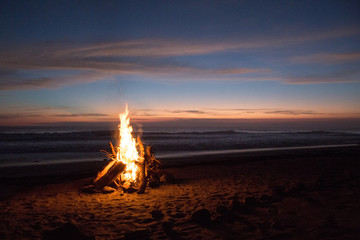 Beach bonfire at sunset by ocean in Nicaragua