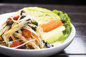Close up of Thai papaya salad with salted crab served with fresh vegetable