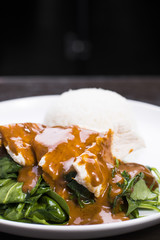 Swimming Rama or steamed spinach and chicken topped with peanut sauce served with rice