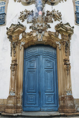 Fototapeta na wymiar Blue vintage door at historic church in Ouro Preto, Brazil