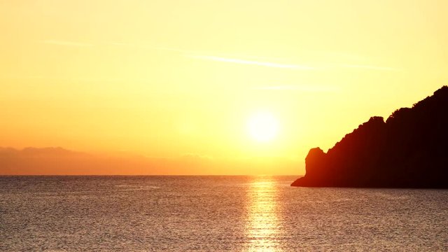 Scenic sunrise sun rising over sea surface, Greece Peloponnese Lakonia, Vlychada Beach, Richea. Timelapse 4K ProRes HQ codec