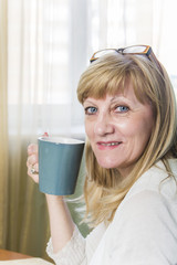 Happy senior lady with a cup of coffee