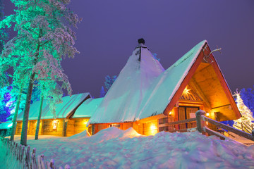 Travel Destinations Concepts. Unique Lapland Suomi Houses Over the Polar Circle in Finland at Christmas Time. Located in Front of Amazing Winter Forest Scenery in Finland.