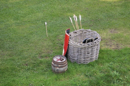 Wooden basket used to store medieval archery equipment, with arrows, shield and a small barrel