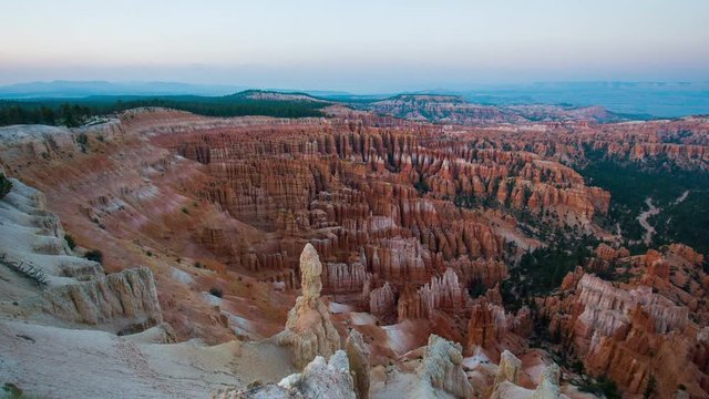 Rays of the setting sun illuminate the pink cliffs. Breathtaking view of the canyon. Amazing mountain landscape. Bryce Canyon National Park. Utah. USA. 4K, 3840