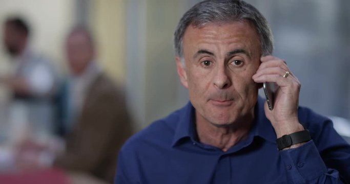 4K Very angry businessman having an argument with someone over the phone. Slow motion.