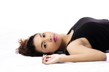 Fototapeta premium Attractive Hispanic Woman Reclining On Back Black Top