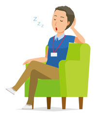 Obraz premium A male staff wearing nameplate sleeps on the sofa