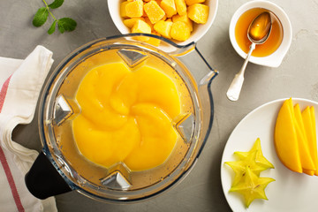 Making smoothie with frozen mango