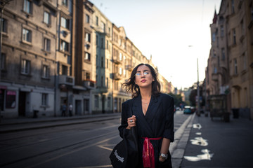 Naklejka na ściany i meble Woman walking on the streets of Prague full of multiculturalism