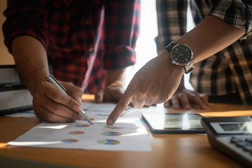 Startup business people group meeting. People group sitting on conference together and making notes. hands pointing at business document during discussion at meeting.