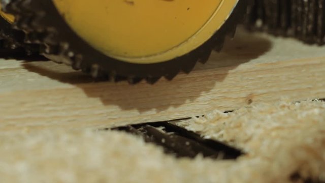 Rolling spiked wheels of plank refiner machine working on wood at carpenter factory, close up