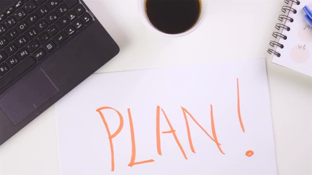 PLAN word written on office desk paper 4K