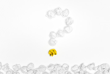 Question mark sign with stack crumpled paper balls on white background