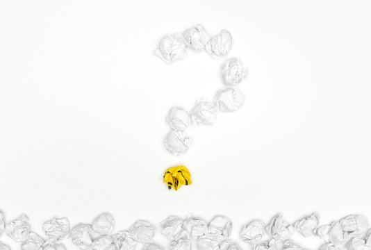 Question mark sign with stack crumpled paper balls on white background