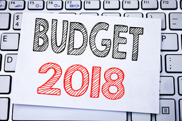 Handwritten text caption showing Budget 2018. Business concept writing for Household budgeting accounting planning written on sticky note paper on the white keyboard background.