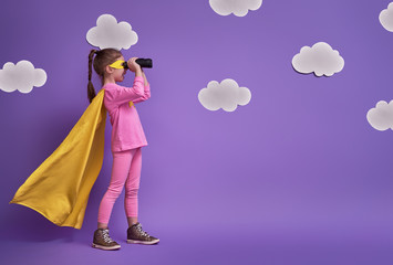 child is playing superhero