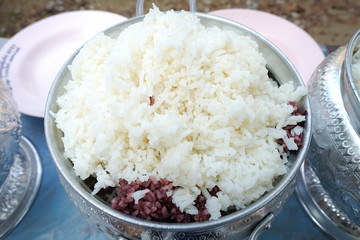 Jasmine rice in white jar on wooden floor