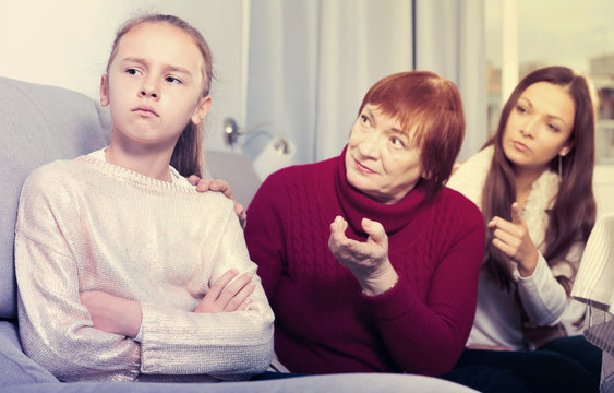 Upset girl scolded by mother and grandma