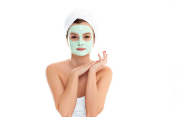 Beautiful woman with clay mask on white background. Beauty and spa