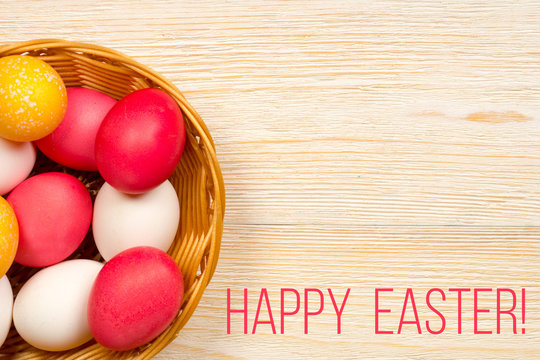 happy easter card with colored eggs in basket