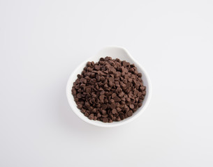 Chocolate chip morsels spread on a background.