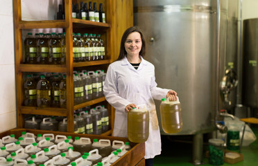 Fototapeta premium girl having olive oil containers