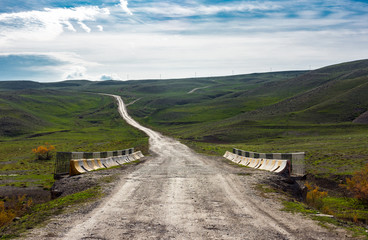 Fototapeta premium Road to mountains in the valley, mountain landscape