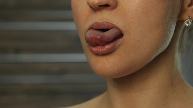 Hot blonde girl licks his lips. tongue work. slow motion