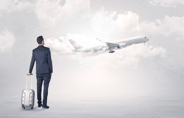 Obraz premium Businessman with luggage walking to airplane