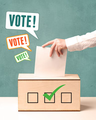 placing a voting slip into a ballot box
