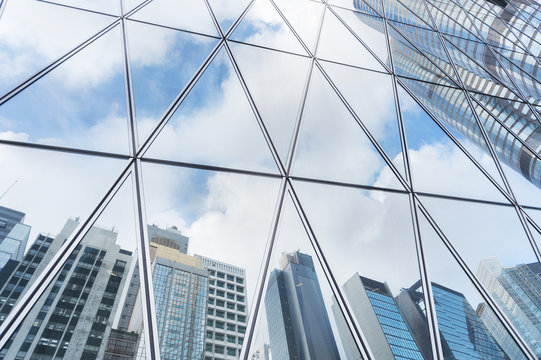 Fototapeta Reflection of urban skyline on modern office building