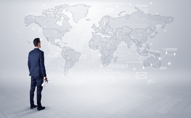 Man looking at map with objects in his hand