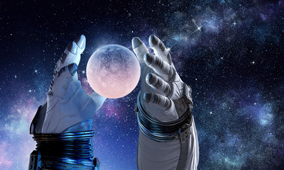 Moon planet in spaceman hand. Mixed media