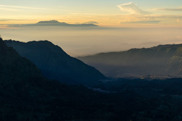 Fototapeta na wymiar Beautiful landscape of Cemero Lawang valley in a morning sunrise, East Java, Indonesia