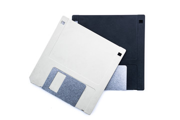 Old vintage computer floppy discs for disk for storing data. On grey and one black on an isolated...