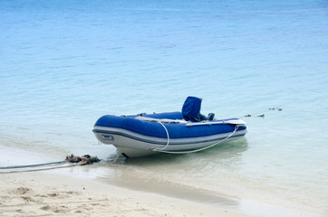 inflatable motor boat on the beach in sunny day