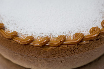 Obraz na płótnie Canvas Vanilla cake withe powdered sugar and milk cream