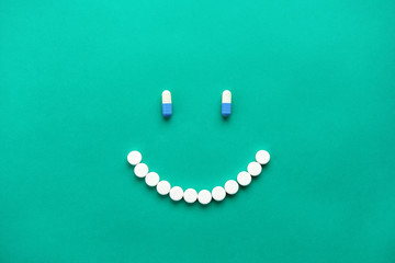 Capsules and pills arranged in smilng face