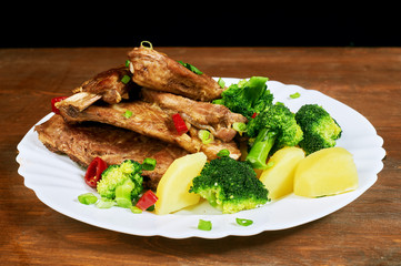 roasted pork ribs with potatoes and vegetables