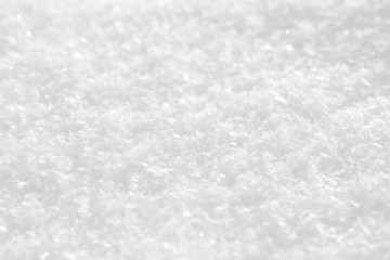 The texture of snow and snowflakes is white. Background for a festive winter postcard.