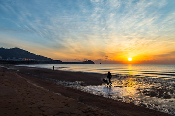 24th Jan 2018, Qingdao, Shandong. Sunrise on Shilaoren Beach, in a morning so cold that the water from the sea is turned into ice