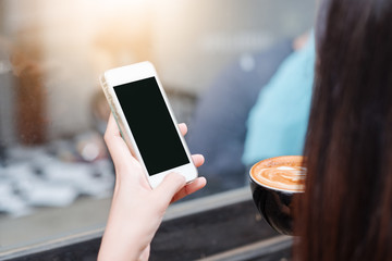business woman sits in airplane watching his cell phone.