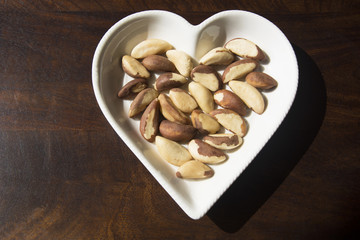 Fresh Brazil Nuts served in a heart shaped plate